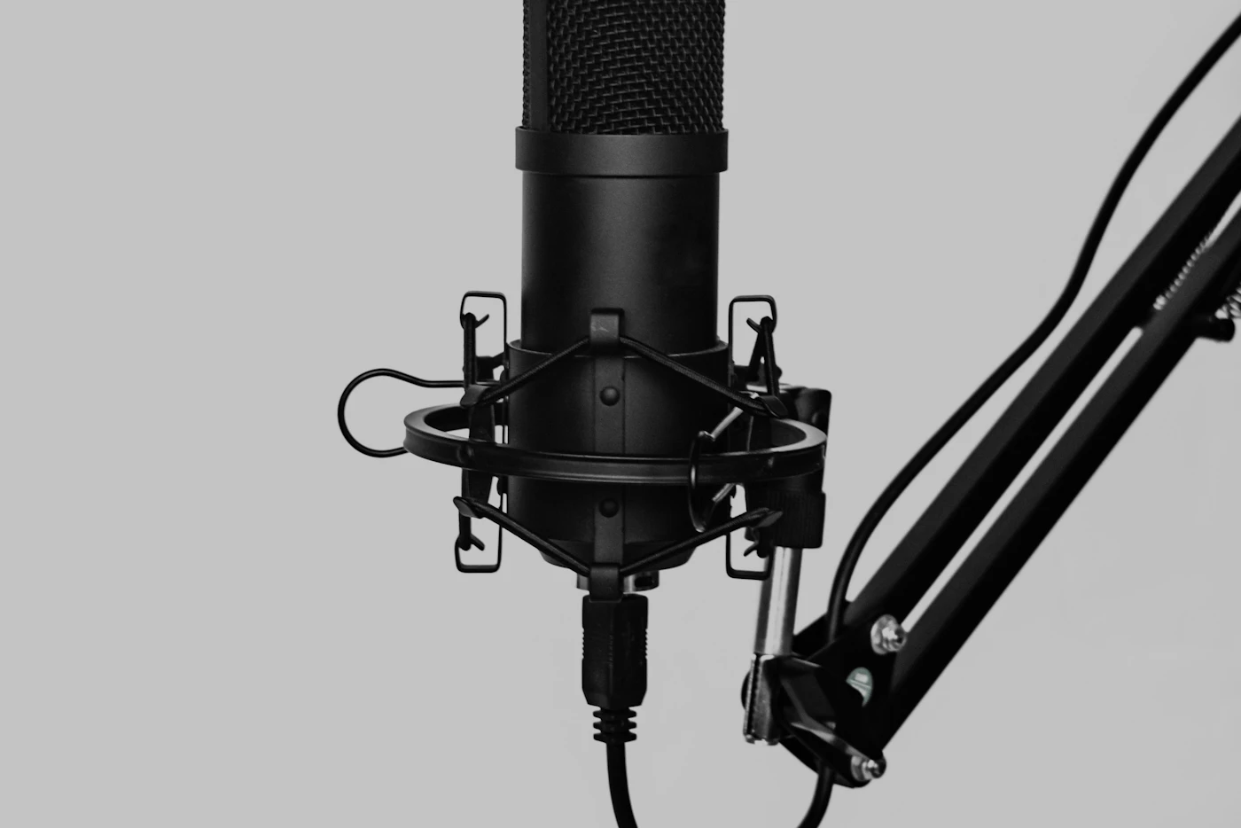 Condenser microphone in a shock mount on a boom arm